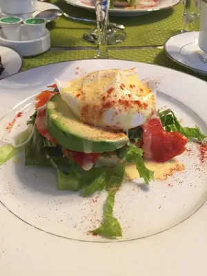 a sandwich with an egg on a plate on a table at Barclay House Bed and Breakfast in Vancouver