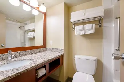 a bathroom with a sink and a toilet and a mirror at Best Western Plus Barclay Hotel in Port Alberni