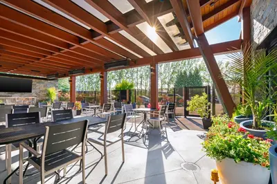 a patio with tables and chairs and plants at Best Western Plus Barclay Hotel in Port Alberni