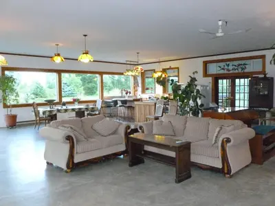 a living room with two couches and a table at Harrison Hammond House Farmstay in Harrison Mills
