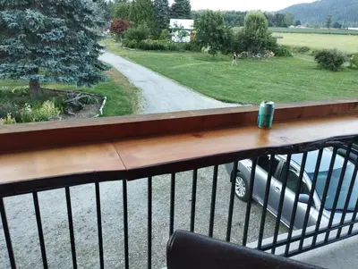 a balcony with a car parked on a road at Harrison Hammond House Farmstay in Harrison Mills