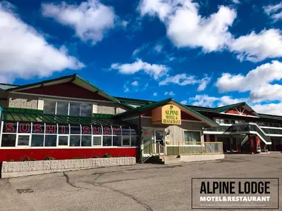 a building with a sign that reads airplane lodge at Alpine Lodge Motel & Restaurant in Grande Cache