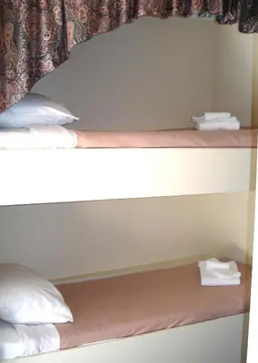 a pair of bunk beds in a room at Motel Tyrol in Radium Hot Springs