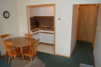 a kitchen and dining room with a table and chairs at Motel Tyrol in Radium Hot Springs
