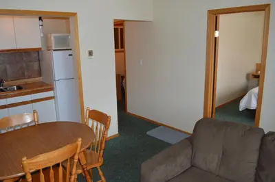 a living room with a couch and a table at Motel Tyrol in Radium Hot Springs