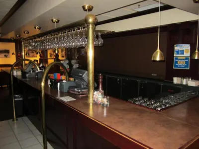 a bar at a restaurant with wine glasses at Woodlands Inn & Suites in Fort Nelson