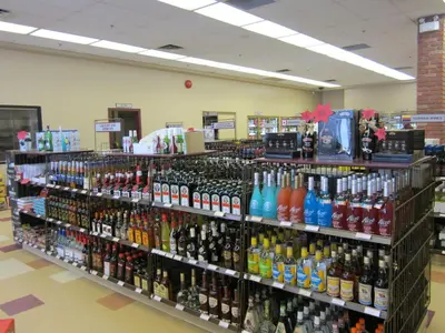 a store filled with lots of bottles of alcohol at Woodlands Inn & Suites in Fort Nelson