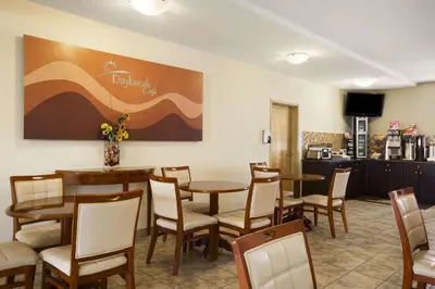 a dining room with tables and chairs in a restaurant at Days Inn by Wyndham Bonnyville in Bonnyville
