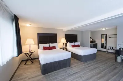 a hotel room with two beds and two lamps at SureStay Hotel by Best Western Castlegar in Castlegar