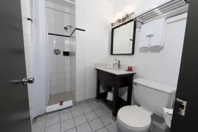 a bathroom with a toilet and a sink and a shower at SureStay Hotel by Best Western Castlegar in Castlegar