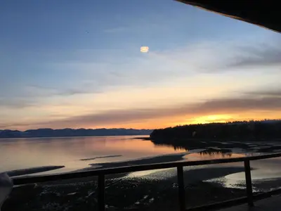 a sunset over a lake with the moon in the sky at The Beach House Texada - Gillies Bay Favourite Cabin in Gillies Bay
