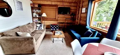 a living room with a couch and a table at The Beach House Texada - Gillies Bay Favourite Cabin in Gillies Bay