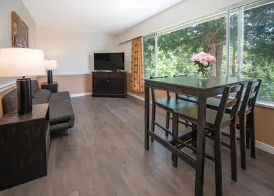 a living room with a table and a couch at Rockwater Secret Cove Resort in Sechelt