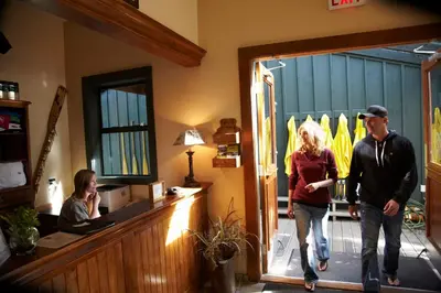 a man and a woman walking into a restaurant at Middle Beach Lodge in Tofino