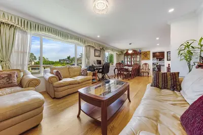a living room with couches and a table at Quite House near the Vancouver Airport in Richmond