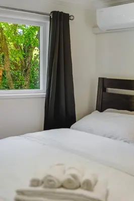a bedroom with a bed with a window at Quite House near the Vancouver Airport in Richmond