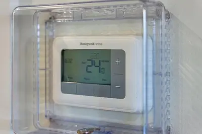 an electronic clock in a plastic container on a wall at Quite House near the Vancouver Airport in Richmond