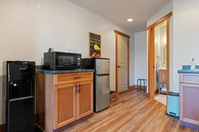 a kitchen with a microwave and a refrigerator at Shawnigan Hills Guest Suite in Shawnigan Lake