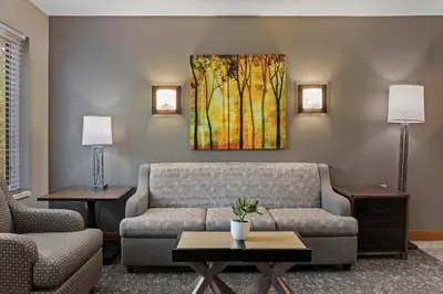 a living room with a couch and a painting on the wall at WorldMark Canmore-Banff in Canmore