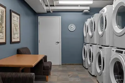 a laundry room with washing machines and a table at WorldMark Canmore-Banff in Canmore