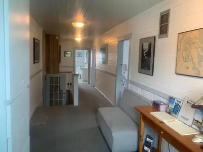 a living room with a couch and a table at Tofino Paddlers Inn in Tofino