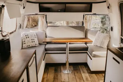 an interior view of an rv with a table and chairs at Mackenzie Beach Resort in Tofino