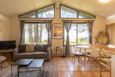 a living room with a couch and a table at Mackenzie Beach Resort in Tofino