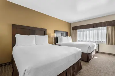 a hotel room with two beds and a window at Best Western Plus Baker Street Inn in Nelson