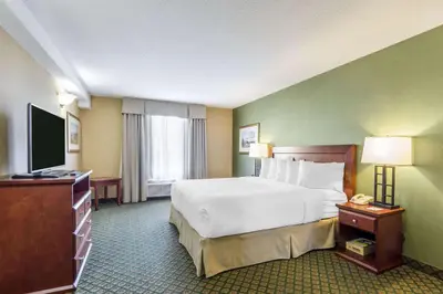 a hotel room with a bed and a flat screen tv at Clarion Hotel & Conference Centre in Sherwood Park