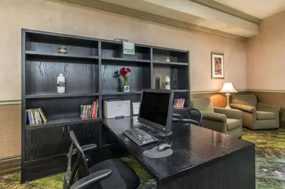 a room with a desk with a computer on it at Clarion Hotel & Conference Centre in Sherwood Park