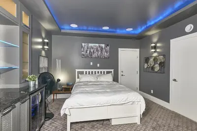 a bedroom with a white bed and a blue ceiling at The Chateau in Burnaby