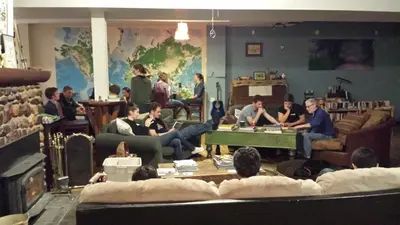 a group of people sitting in a living room playing poker at Dreamcatcher Hostel in Golden