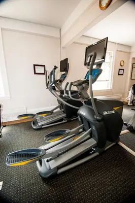 a row of exercise bikes in a gym at The Inn at the Union Club of British Columbia in Victoria