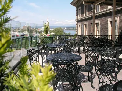 a group of tables and chairs on a balcony at The Inn at the Union Club of British Columbia in Victoria