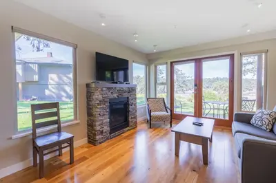 a living room with a couch and a fireplace at Mayne Island Resort in Mayne Island