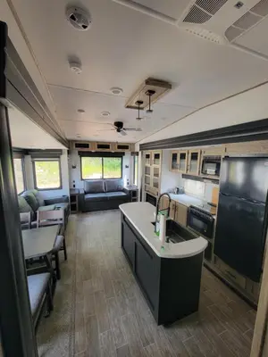 an rv with a kitchen and a living room at Noah's Ark Campground in Revelstoke