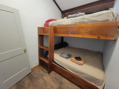 a bunk bed in a room with a door at Noah's Ark Campground in Revelstoke