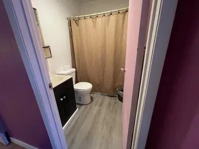 a bathroom with a toilet and a sink at Holiday House Motel in Ladysmith