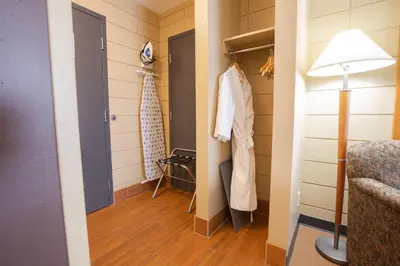 a room with a hallway with a door and a lamp at Neighbourhood Inn Hotels in Bonnyville in Bonnyville