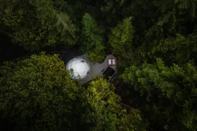 an overhead view of a domed building in the midst of trees at West Coast Trail Lodge in Port Renfrew