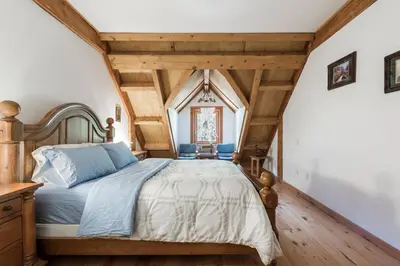 a bedroom with a large bed in a attic at Owl Street Lodge in Hope