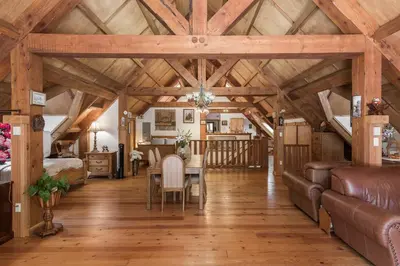 a living room with a table and a couch at Owl Street Lodge in Hope