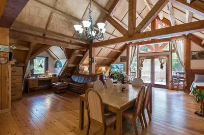 a dining room with a wooden table and chairs at Owl Street Lodge in Hope