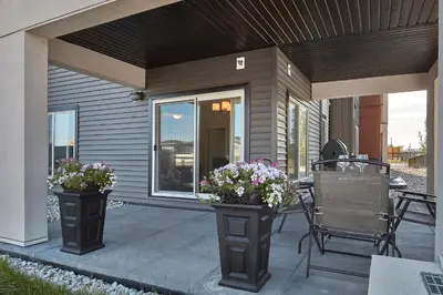 a patio with two vases with flowers on it at 5 STAR Business Luxury Homeshare in Edmonton