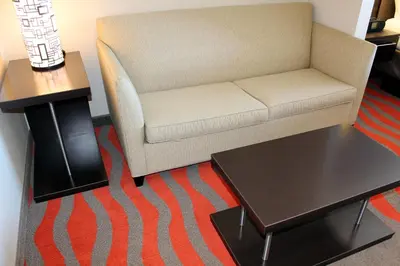 a living room with a couch and a coffee table at Chateau Inn & Suites Bonnyville in Bonnyville