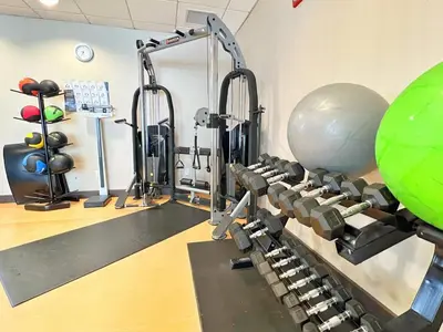 a gym with exercise equipment and a large exercise ball at Chateau Inn & Suites Bonnyville in Bonnyville