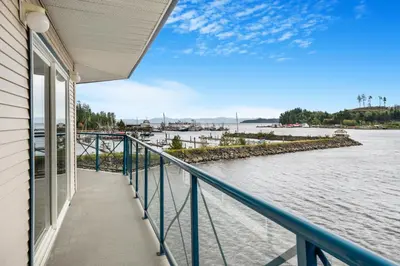 a balcony of a house with a view of the water at Glen Lyon Inn in Port Hardy