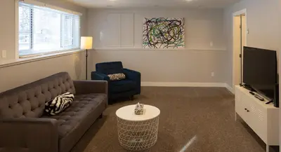 a living room with a couch and a tv at Stoneshire Guesthouse in Clearwater