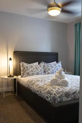 a bedroom with a bed with two towels on it at Stoneshire Guesthouse in Clearwater