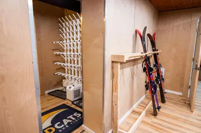 a room with skis hanging on the wall at Red Shutter Inn in Rossland